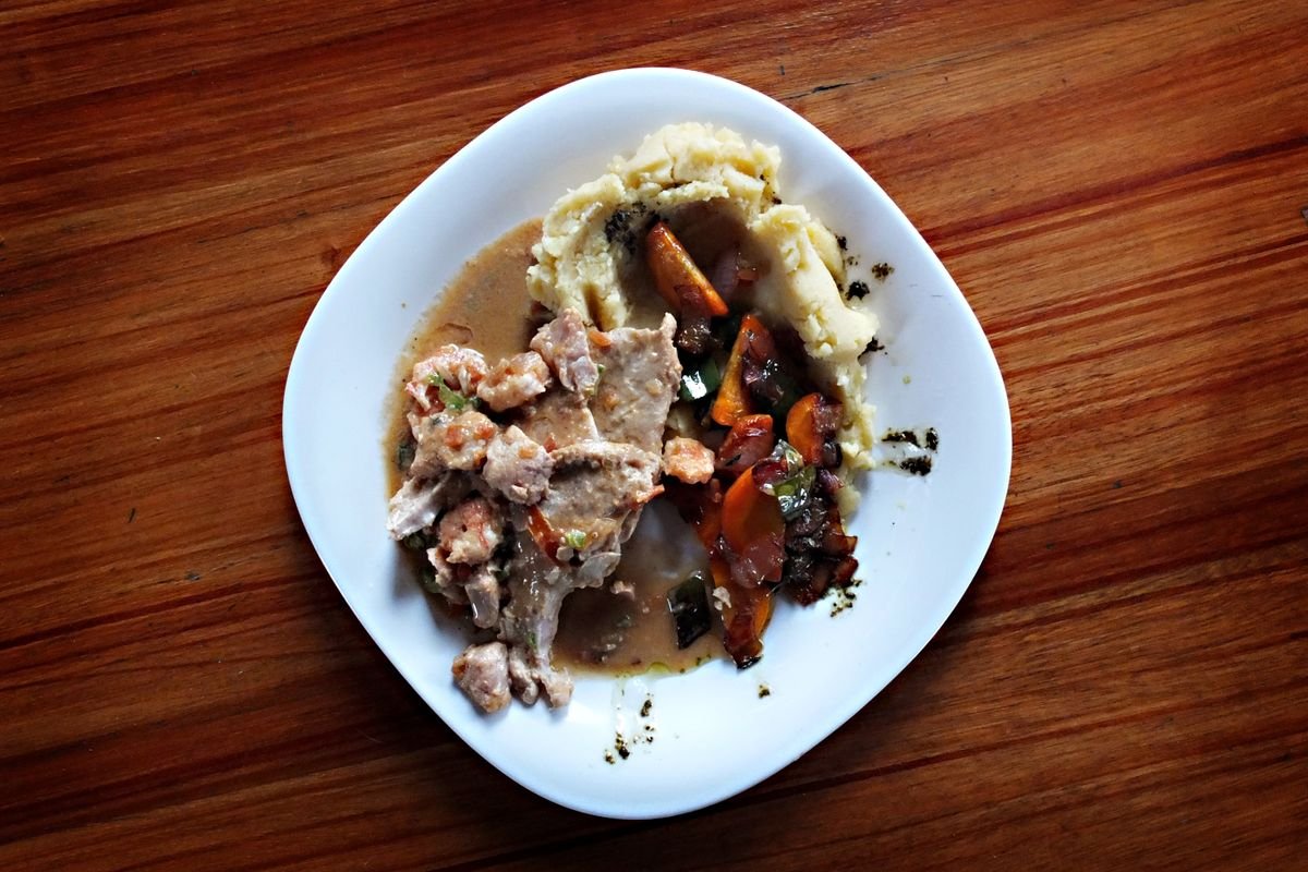 Balanced dinner with meat, vegetables and mashed potatoes on a wooden table