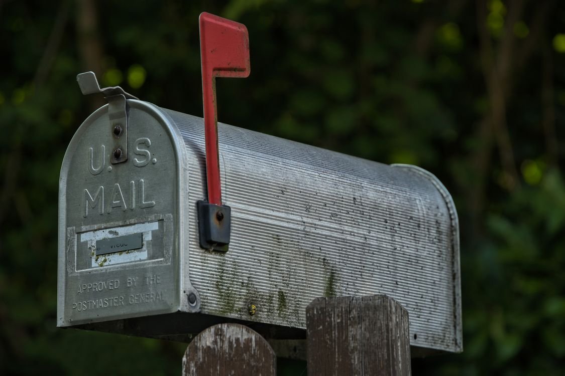 Metal US mailbox with the red flag raised