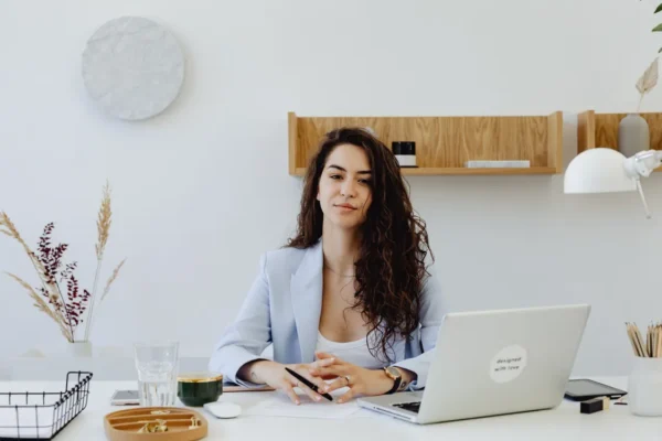Small business owner planning task automation on a laptop at her desk