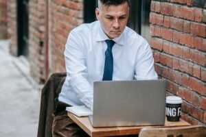 Small business owner working on a laptop in a cafe