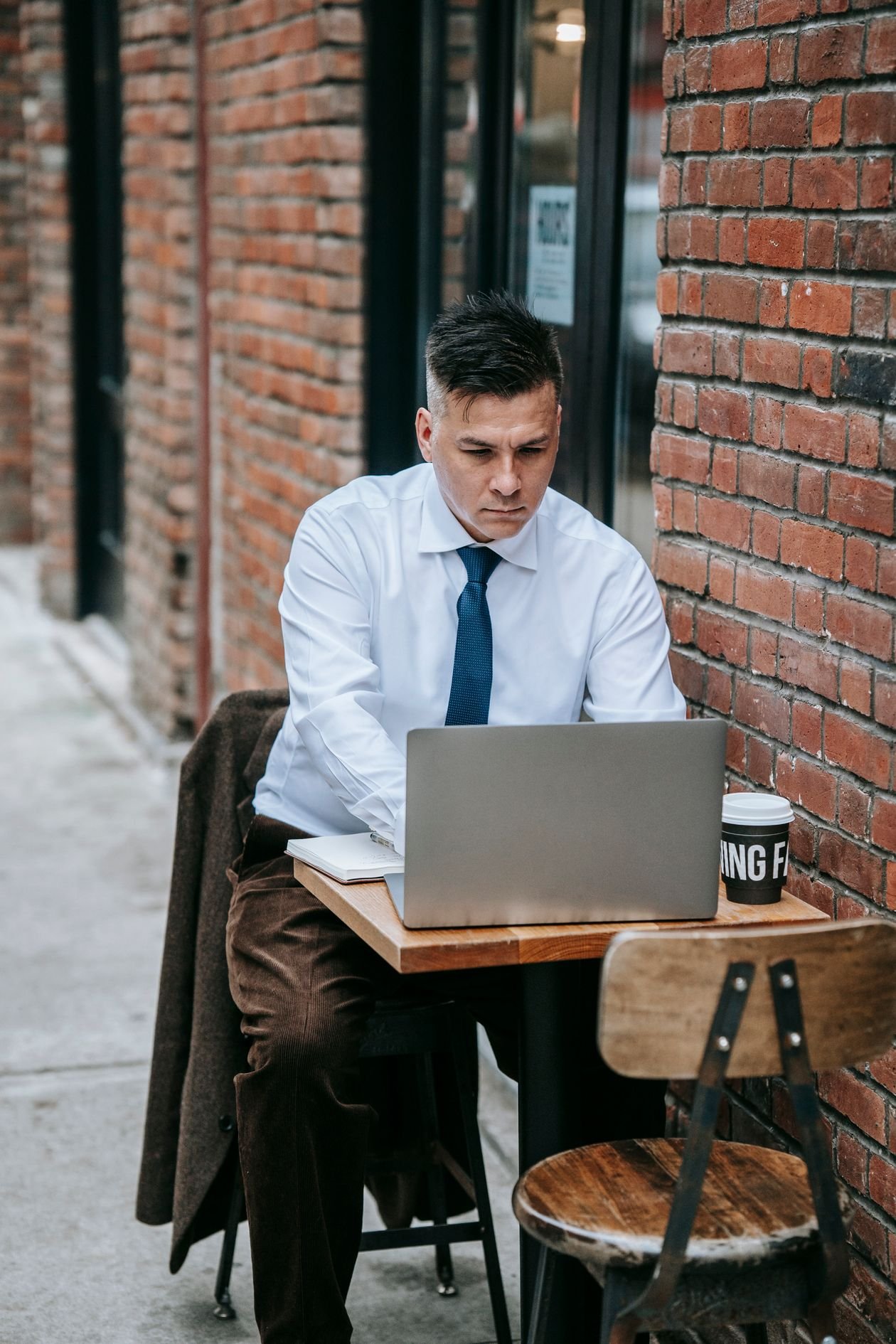 Small business owner working on a laptop in a cafe