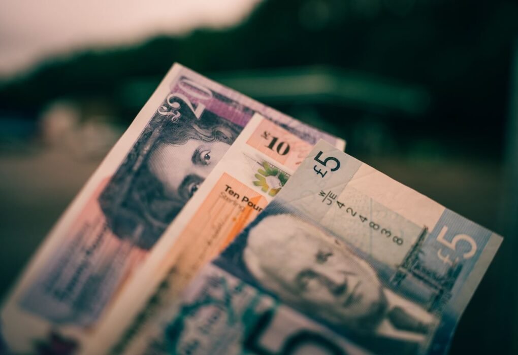 Close up of British pound sterling banknotes in five pound, ten pound and twenty pound notes