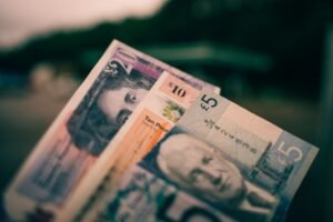Close up of British pound sterling banknotes in five pound, ten pound and twenty pound notes