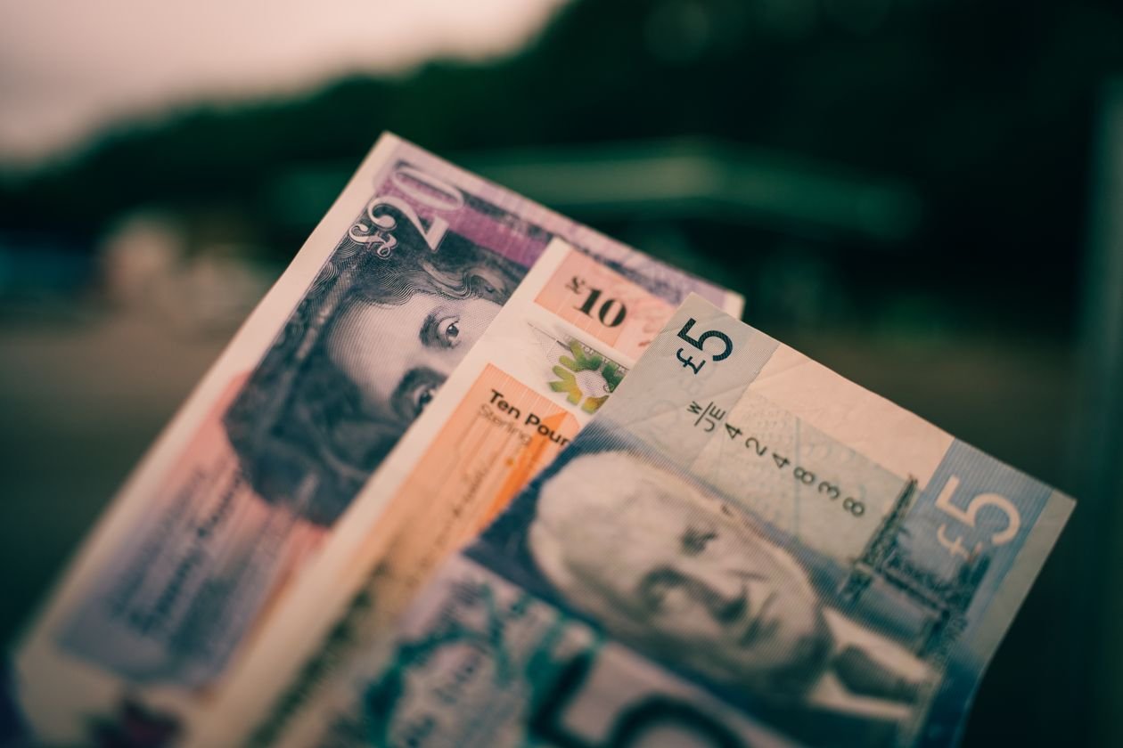 Close up of British pound sterling banknotes in five pound, ten pound and twenty pound notes