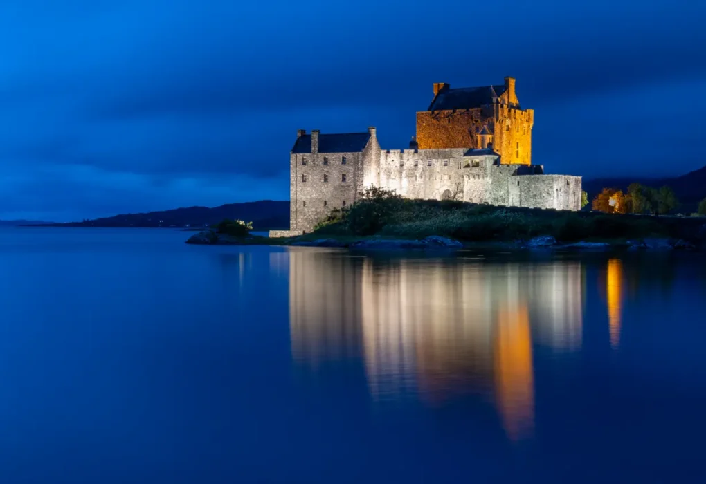 Stone castle in the Scottish Highlands under a misty sky, the style of setting used for The Traitors