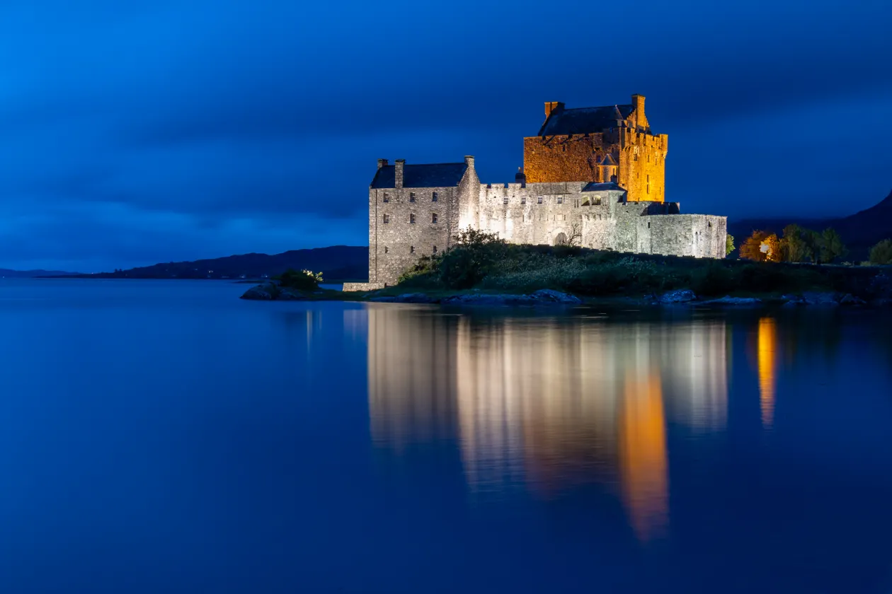 Stone castle in the Scottish Highlands under a misty sky, the style of setting used for The Traitors