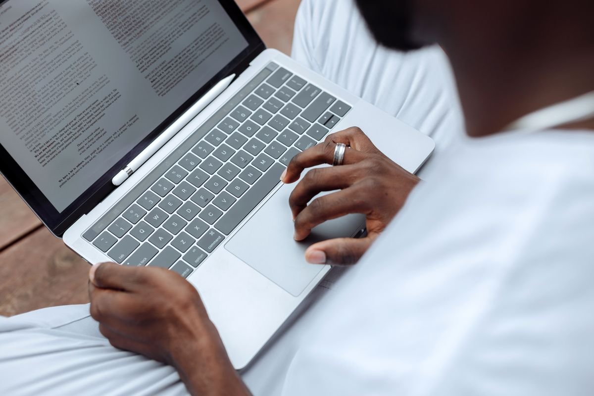Business professional typing a business email in English on a laptop