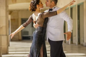 Ballroom dancing couple performing under stage lights on Strictly Come Dancing