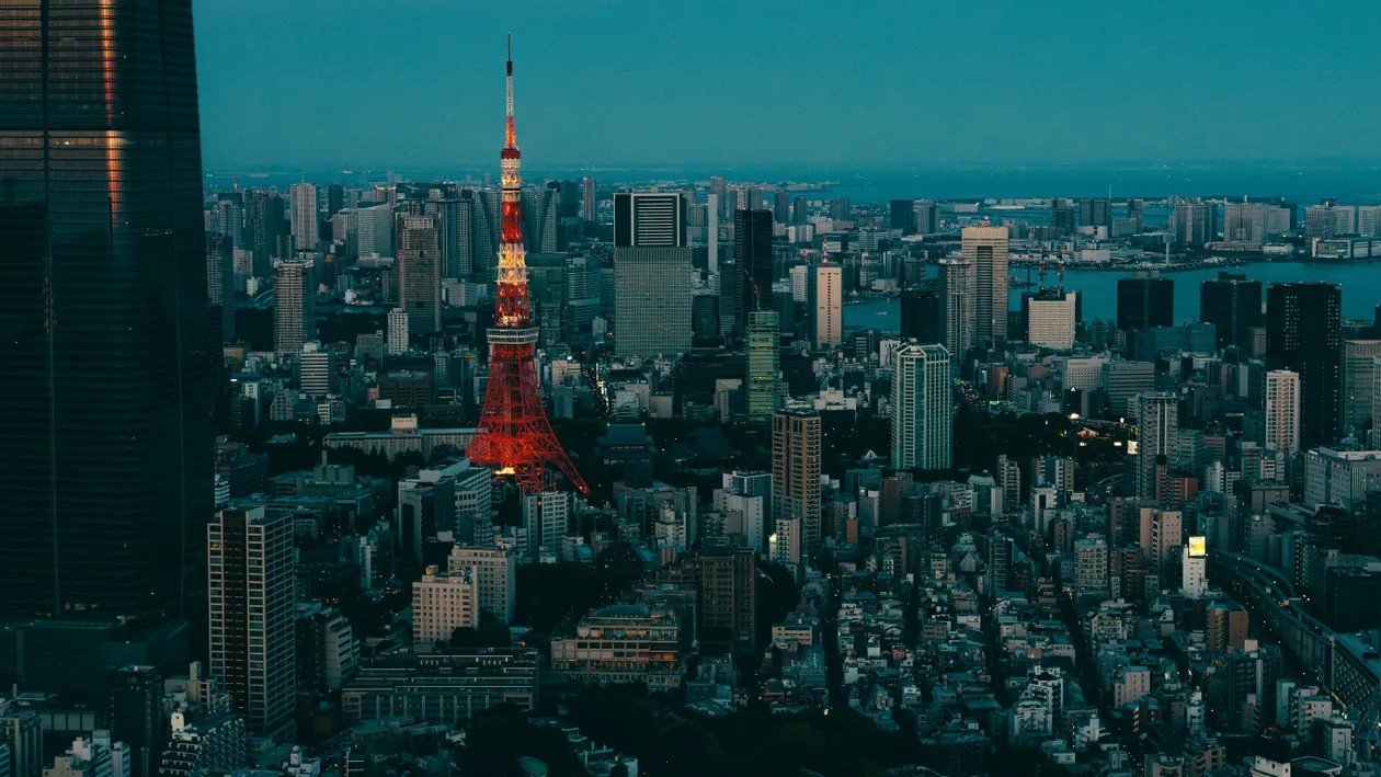 Tokyo Tower rising above the city skyline in the evening