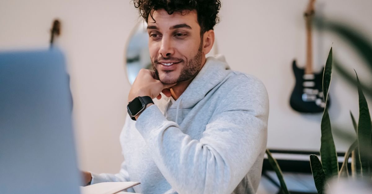 Freelancer working on a laptop at a home office desk