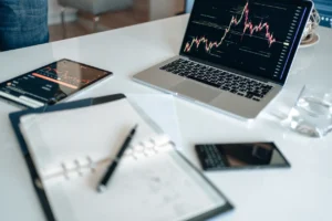 Laptop with charts and notebook on an office desk
