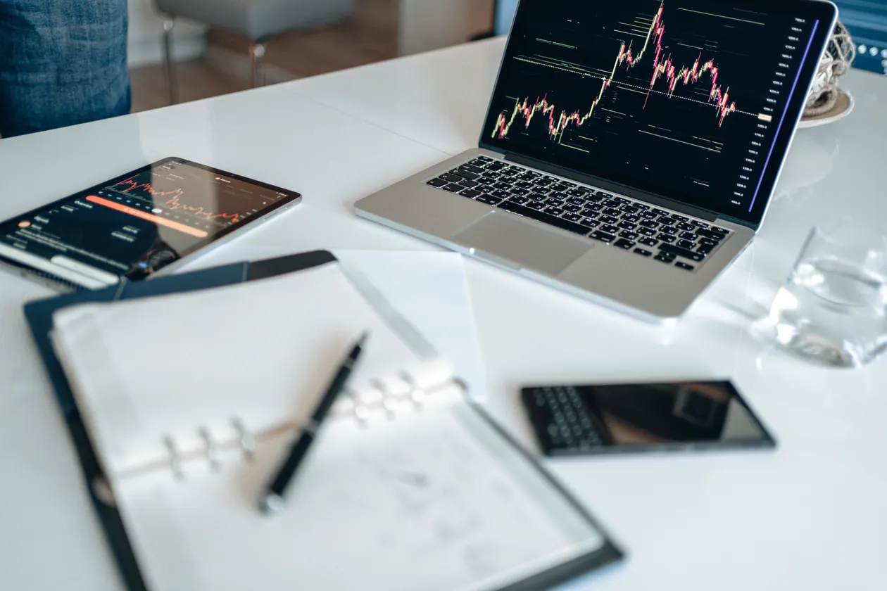 Laptop with charts and notebook on an office desk