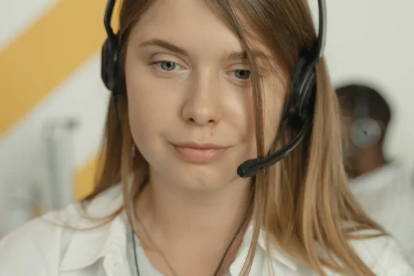 Customer support agent wearing a headset handling a complaint professionally
