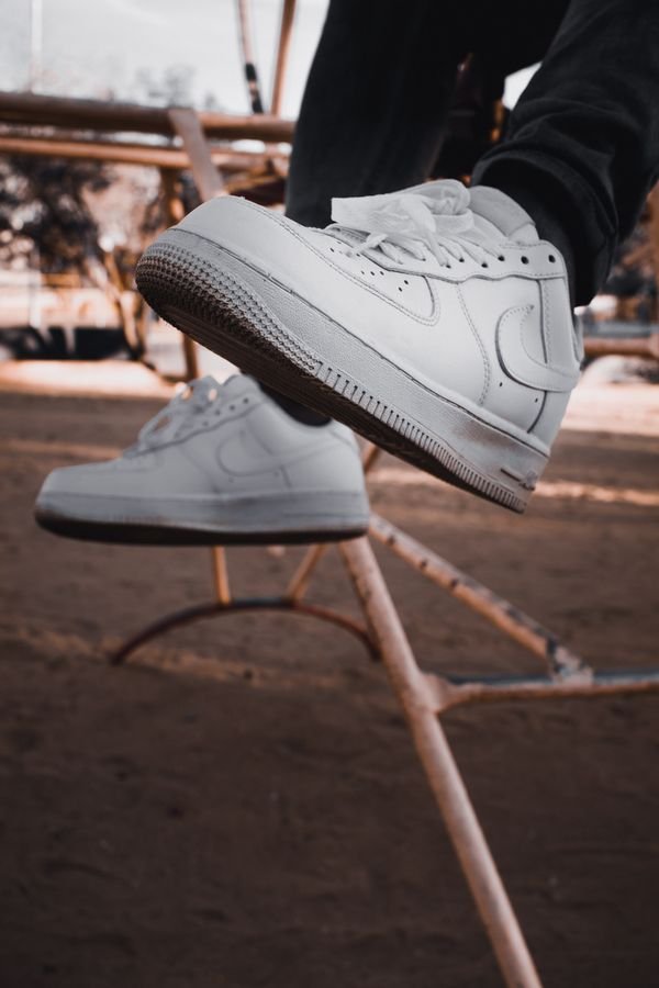 Person wearing clean white sneakers outdoors after washing