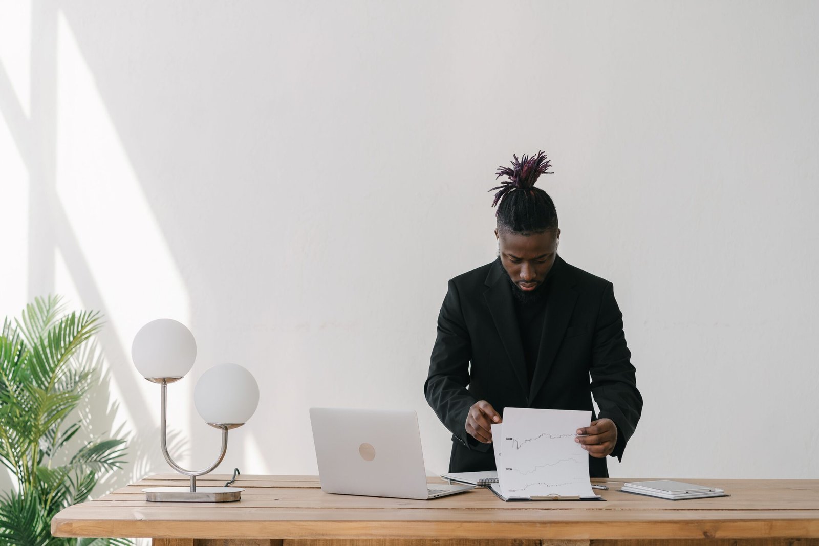 Businessman working on a laptop at an office desk reviewing important business files