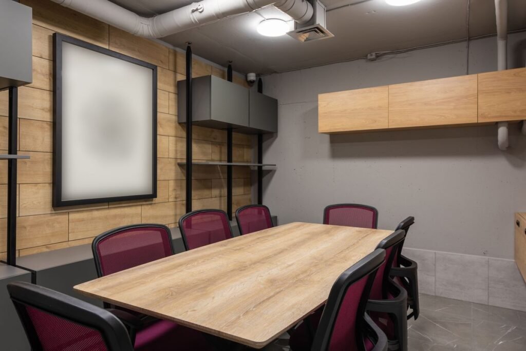 Small meeting room with wood slat wall panels that soften reflected sound