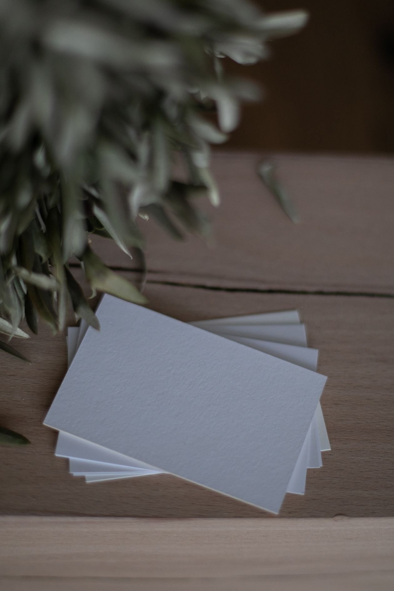 Stack of business cards on a wooden table
