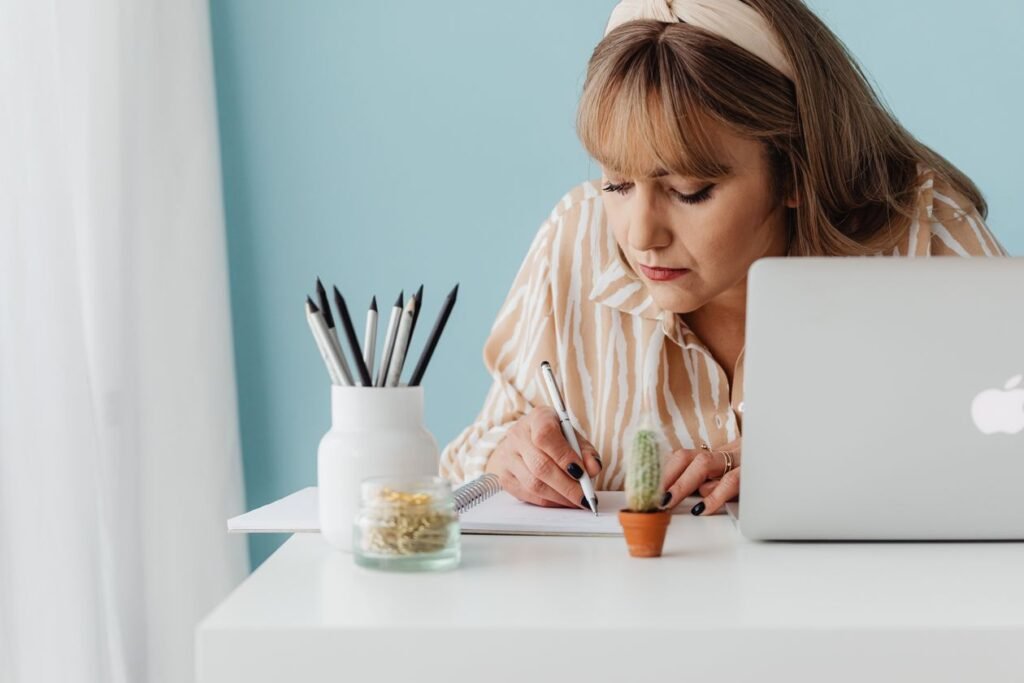 Woman using a laptop to review online survey responses