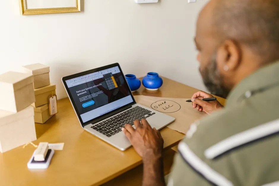 Business owner at a laptop, ready to ask a client for a testimonial
