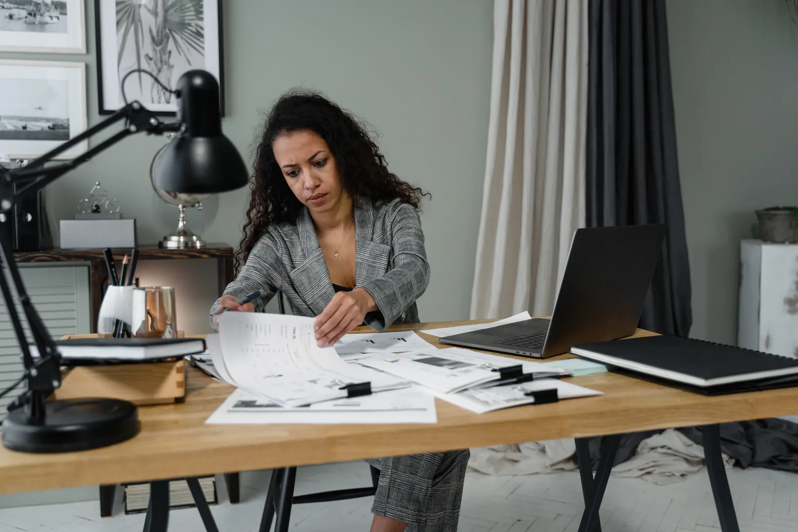 Small business owner sorting through admin paperwork that could be delegated to a virtual assistant