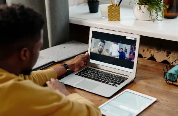 Business owner running an online focus group on a laptop video call
