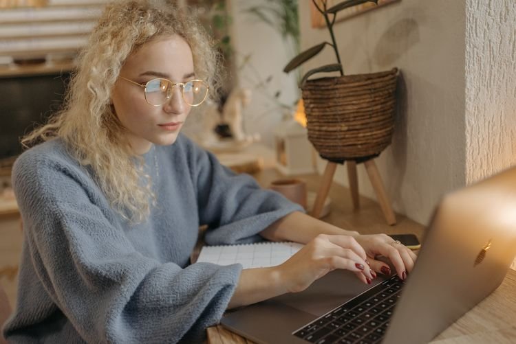 Professional woman sitting at her office desk working on her laptop