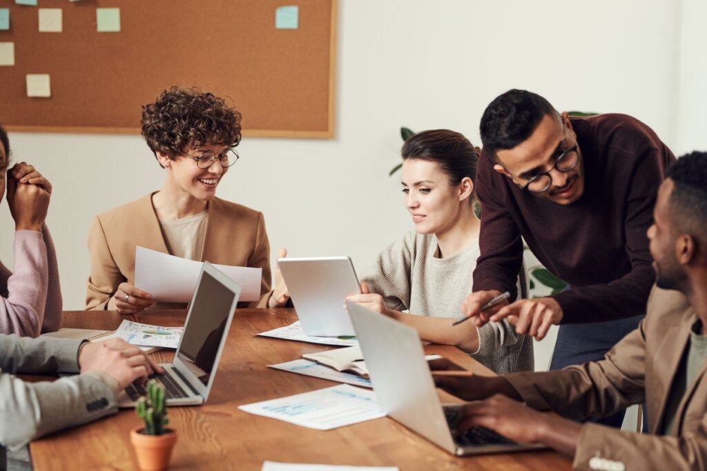 Diverse small business team collaborating around a table in an office