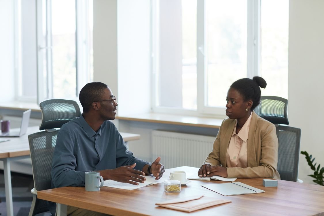 Job interview conversation between employer and candidate in an office