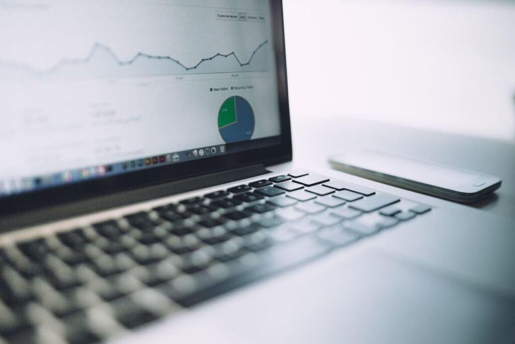 Laptop screen showing an analytics dashboard with charts and graphs for measuring interest