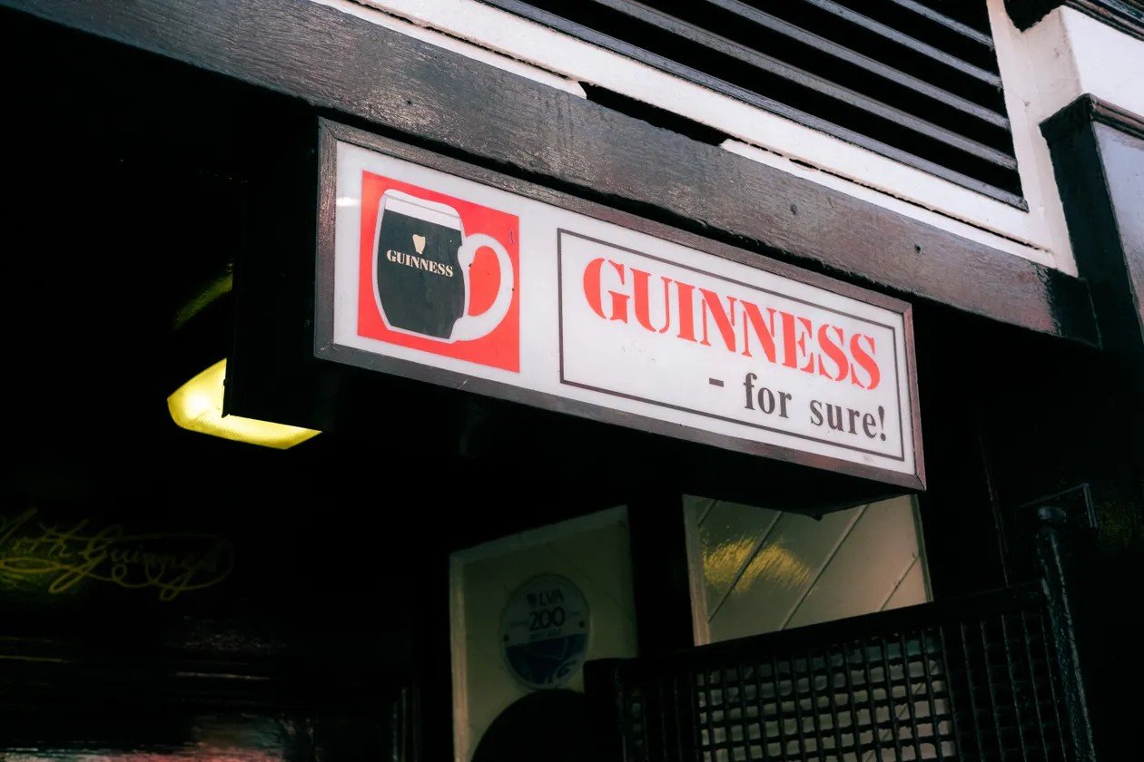Vintage Guinness pub sign outside a pub attracting passing footfall