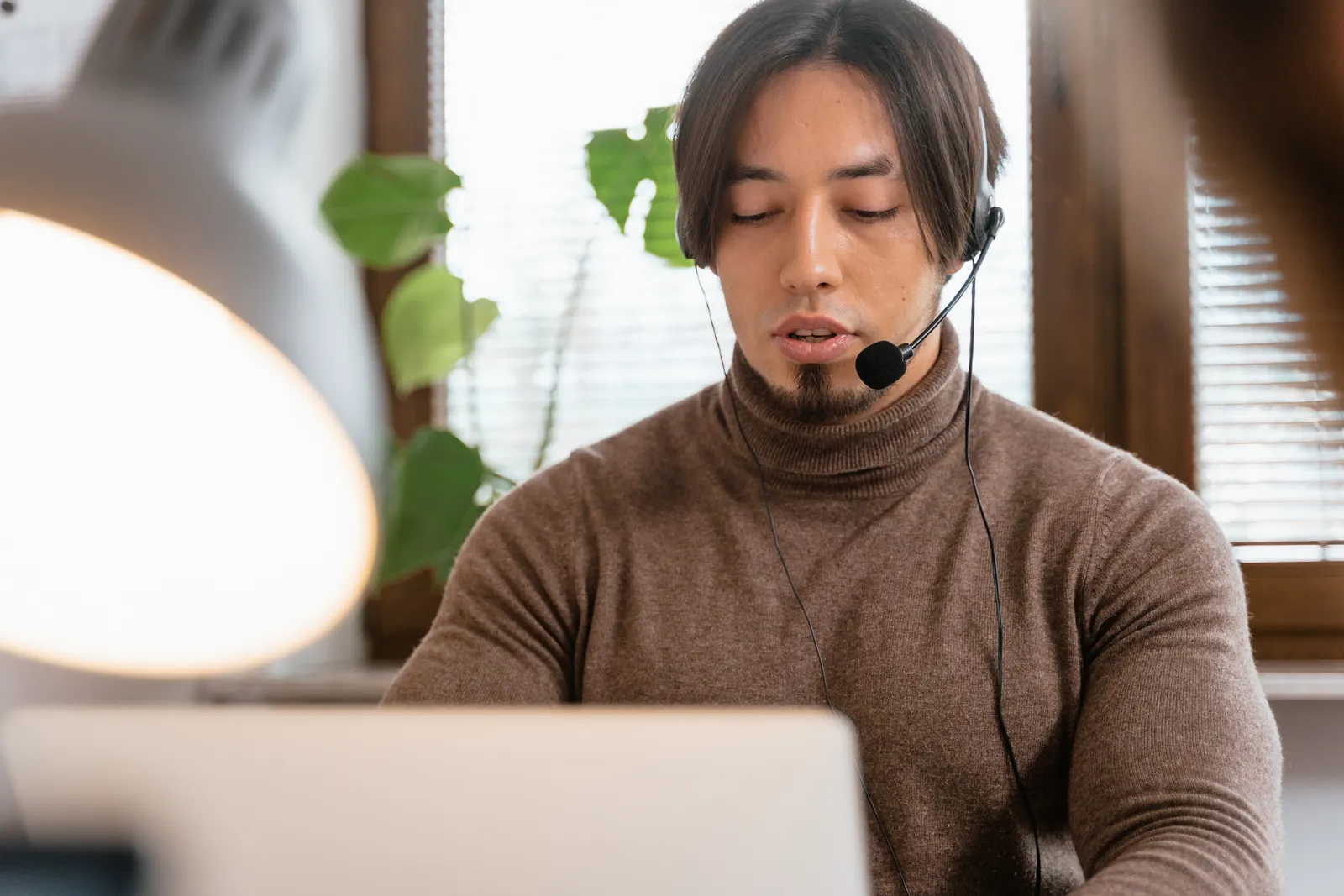 Virtual assistant with headset handling customer calls from a home office