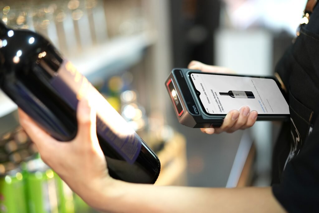 Shop assistant scanning a product barcode with a handheld scanner