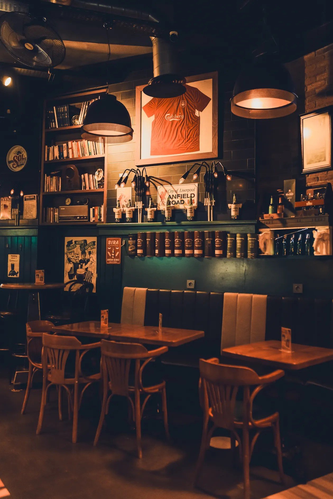 Warm traditional pub interior with wooden tables set out for quiz night