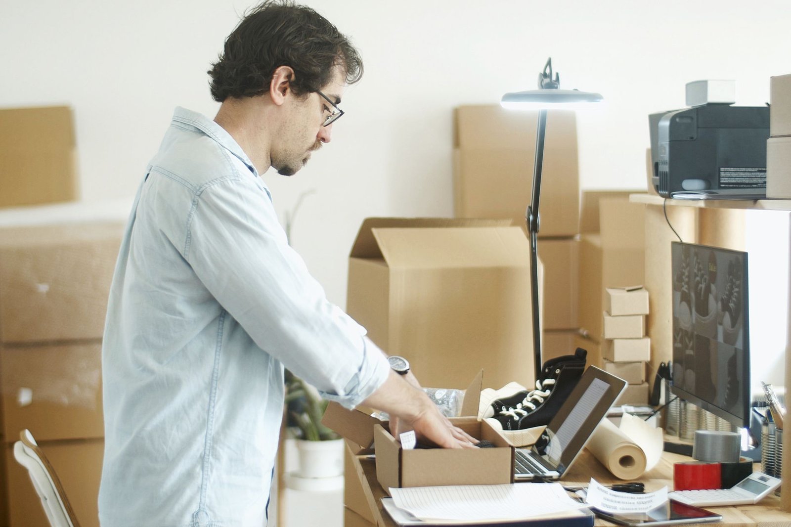 Small business owner packing customer orders before the holiday season