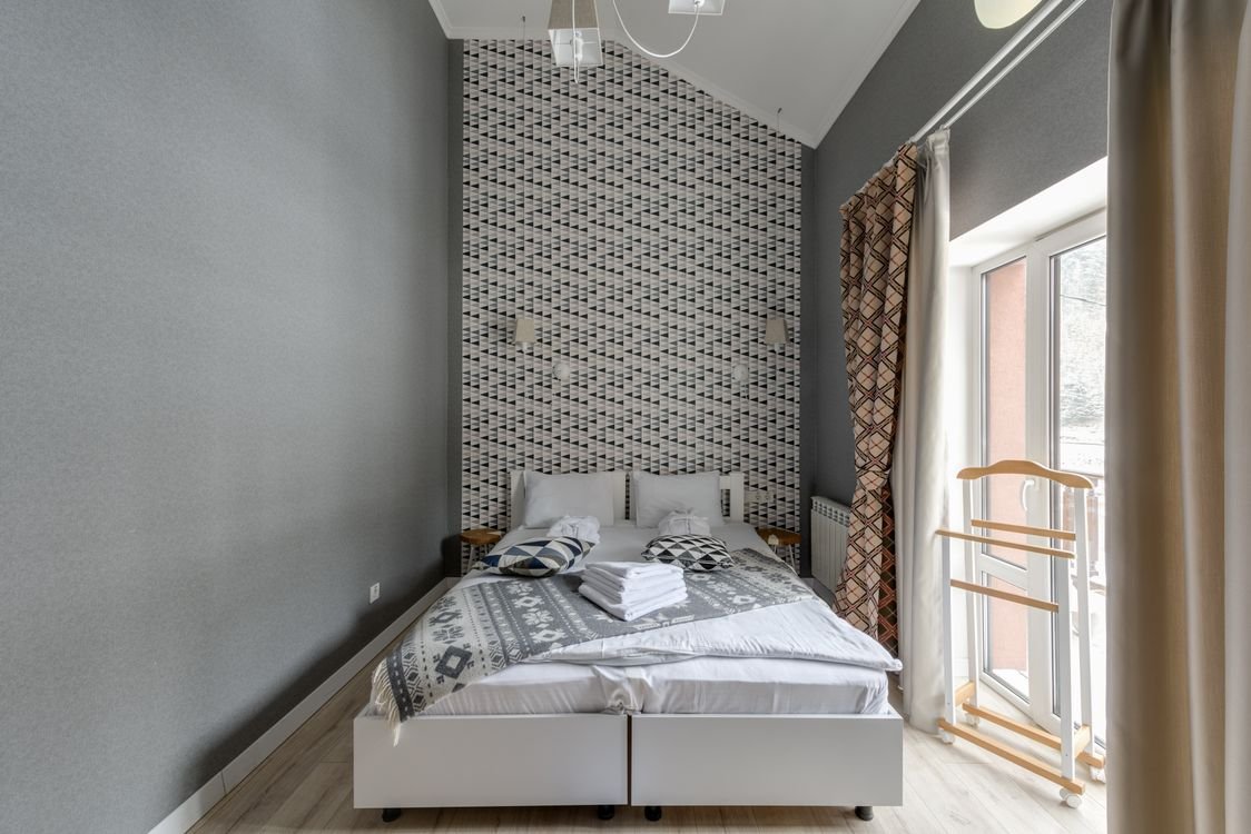 Tidy spare bedroom with a neatly made bed ready for guests