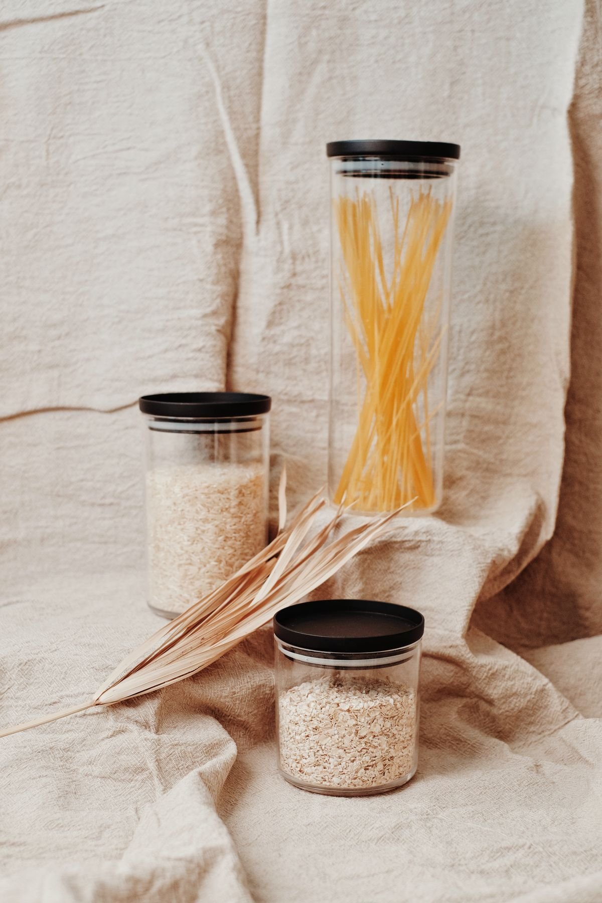 Reusable glass jars filled with pasta and grains for eco friendly storage