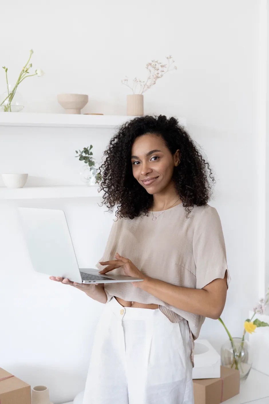 Smiling business owner using her laptop to publish client testimonials