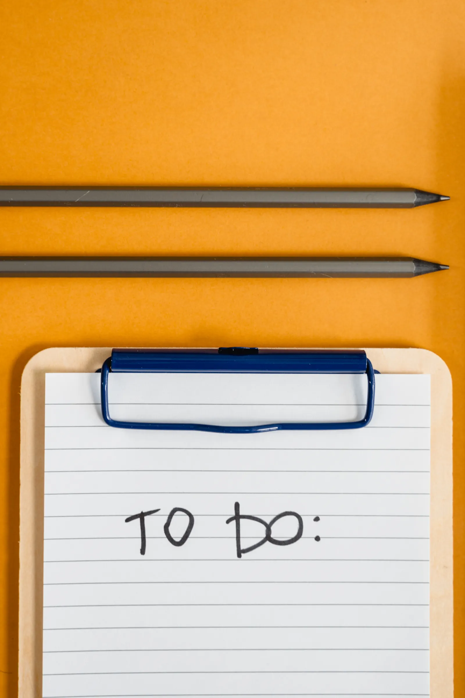 Clipboard with a handwritten to do list for planning tasks to delegate to a virtual assistant