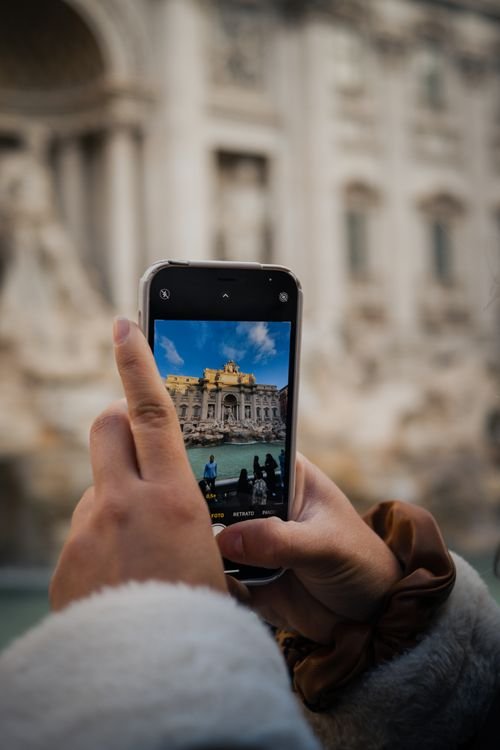 Tourist holding a smartphone to check maps while traveling