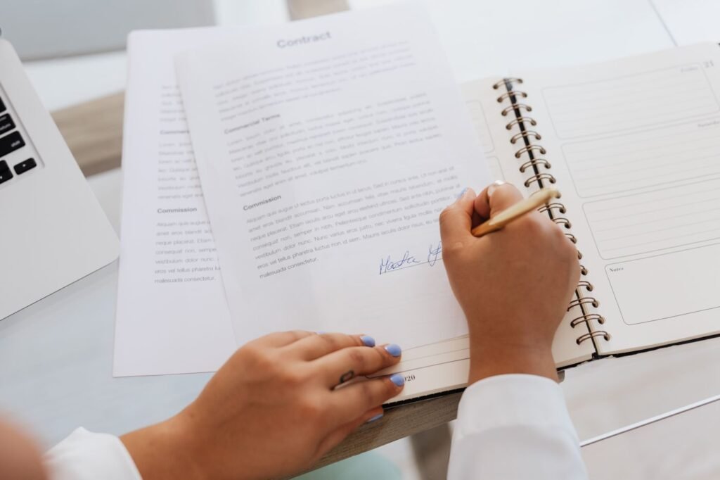 Business owner signing a client contract with clear terms
