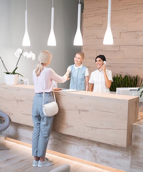Friendly dental clinic reception where confirmed patients arrive for their appointments