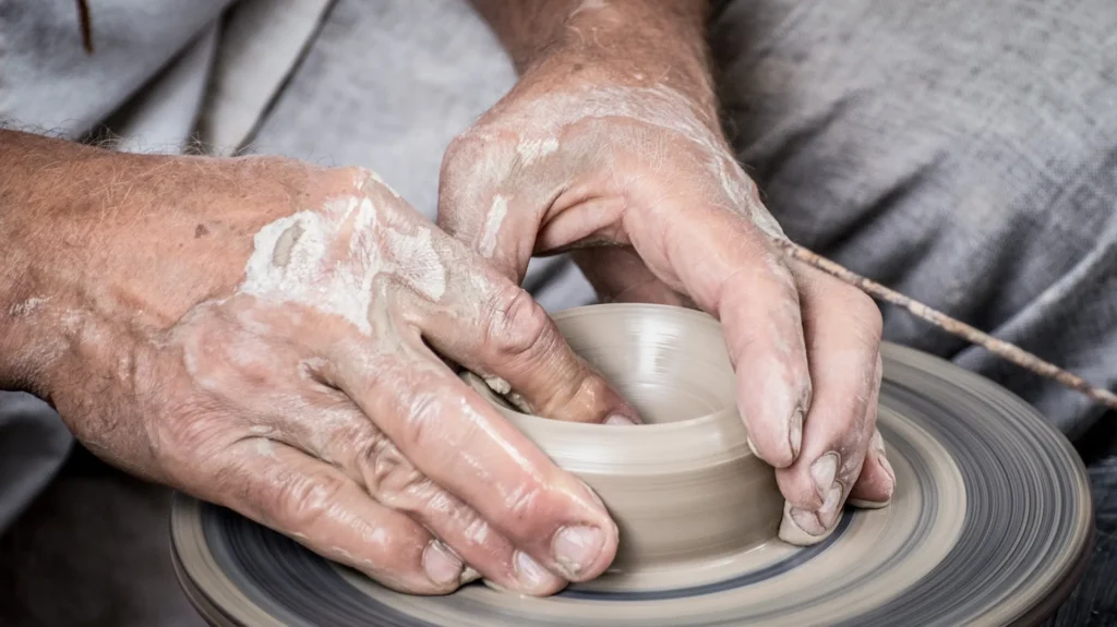 Close up of a craft makers hands at work on a handmade item