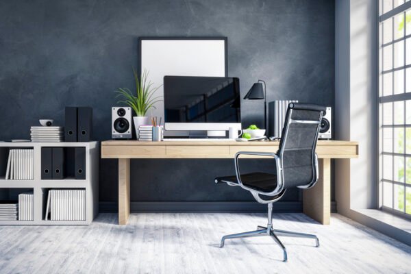 Organised desk with laptop and notebooks in a tidy small business home office