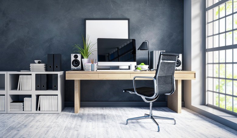 Organised desk with laptop and notebooks in a tidy small business home office