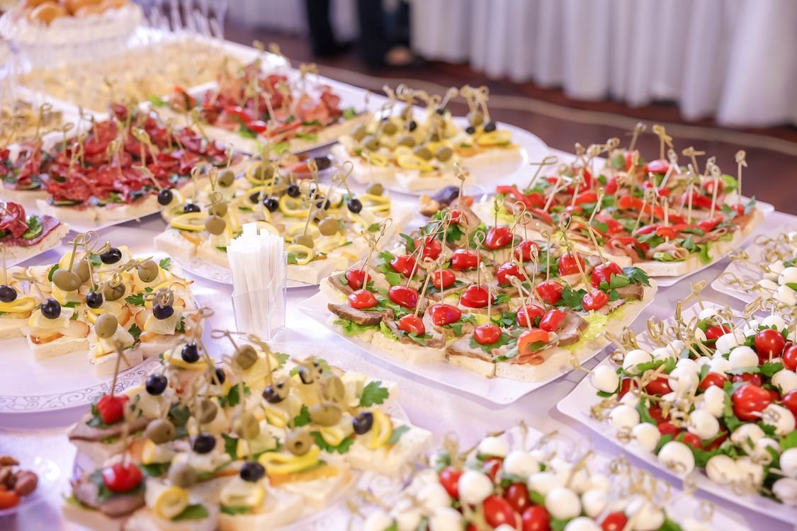 A low cost buffet table of finger food and drinks laid out for a staff party