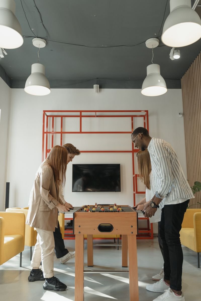 Colleagues laughing together during a quiz game at a budget friendly office party