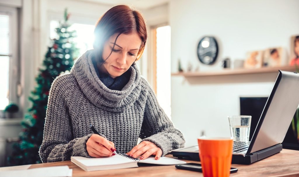 Shop owner planning a festive Christmas display for customers